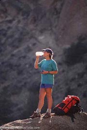 A woman mountain biking; Actual size=180 pixels wide